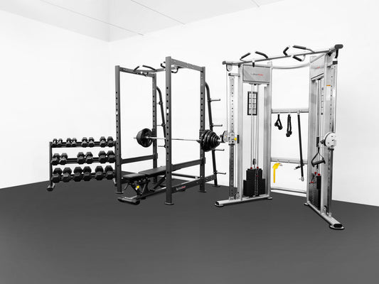 Gym equipment including a power rack, dumbbells, and a cable machine on a gray floor.