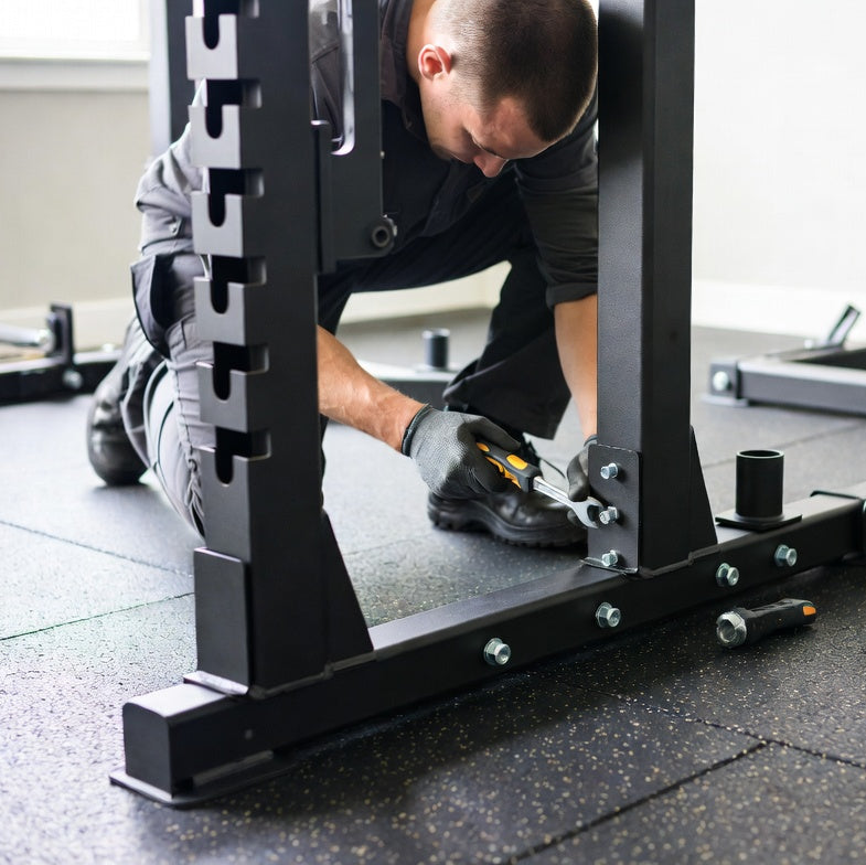 Person assembling a weightlifting bench in a gym setting